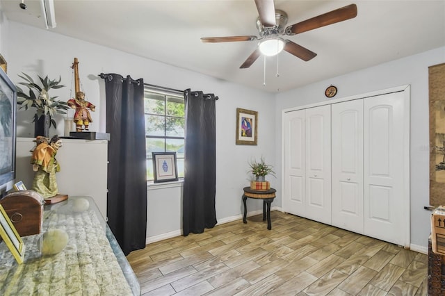 bedroom with light wood-style floors, a ceiling fan, baseboards, and a closet