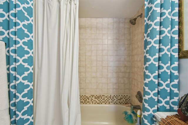 bathroom with shower / bath combo with shower curtain