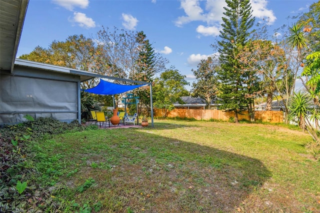 view of yard with a fenced backyard and a patio