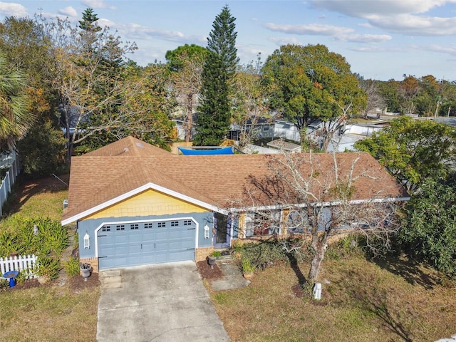 view of front of property featuring brick siding, a shingled roof, an attached garage, fence, and driveway