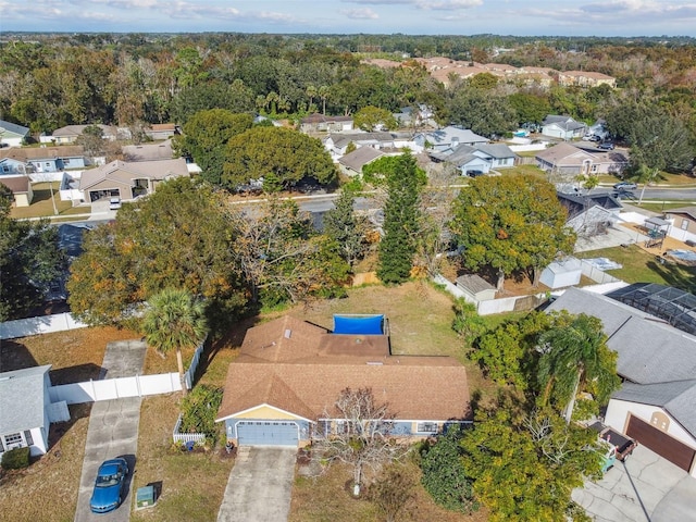 drone / aerial view with a forest view and a residential view