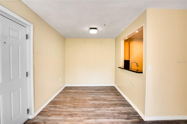 unfurnished room with hardwood / wood-style flooring