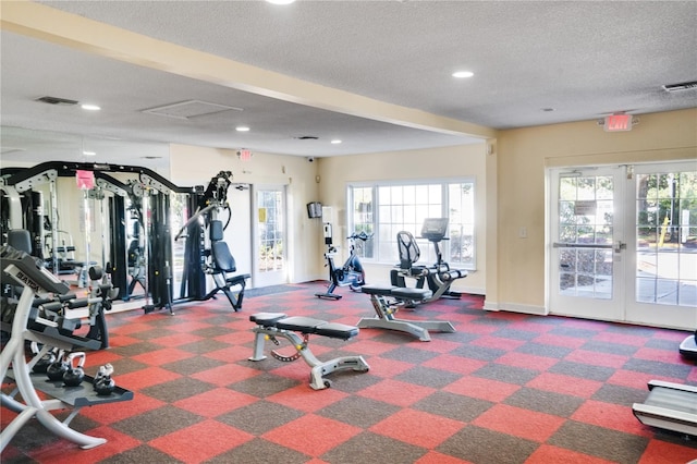 gym featuring a wealth of natural light, french doors, and a textured ceiling