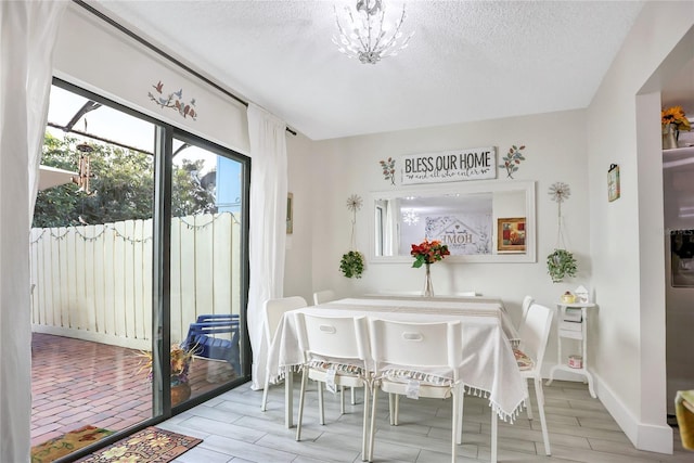 dining space featuring a textured ceiling and light hardwood / wood-style flooring