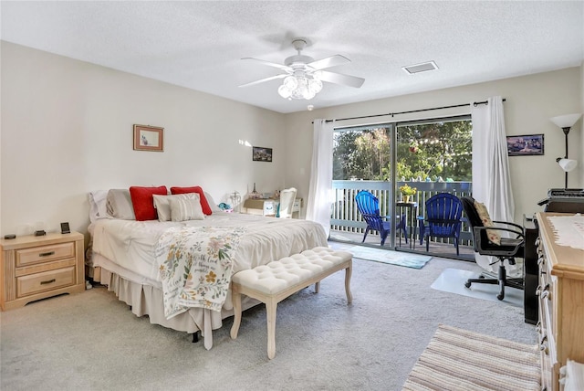 bedroom with ceiling fan, light colored carpet, a textured ceiling, and access to outside