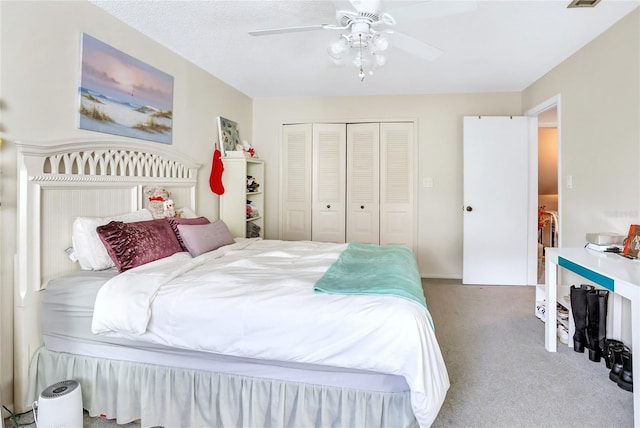 bedroom with carpet, a textured ceiling, a closet, and ceiling fan