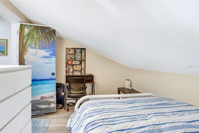 bedroom with light hardwood / wood-style floors and vaulted ceiling