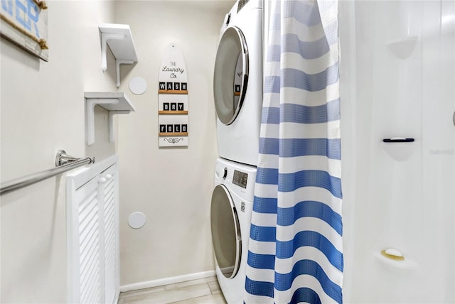 bathroom featuring stacked washer and clothes dryer