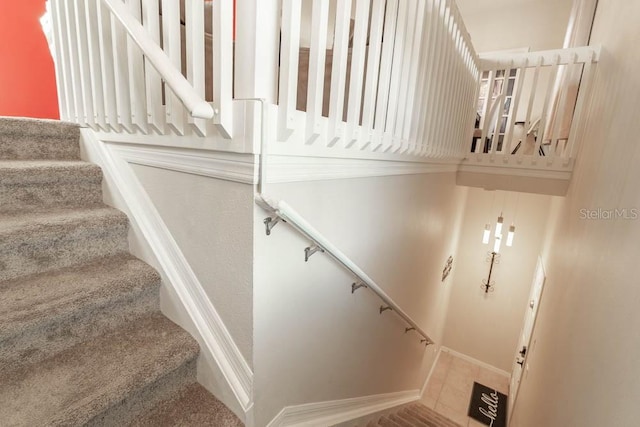 staircase with tile patterned floors