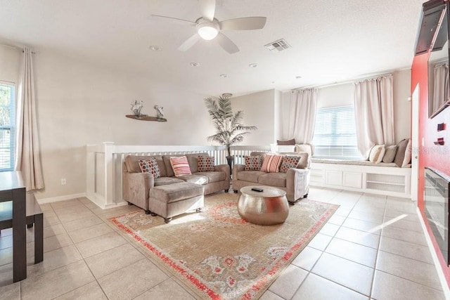 tiled living room featuring ceiling fan