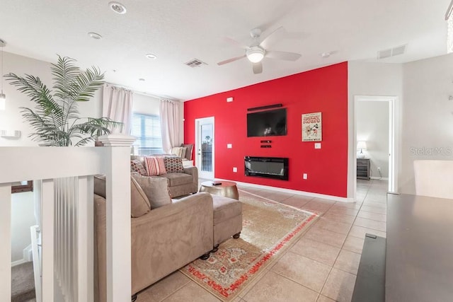 tiled living room featuring ceiling fan