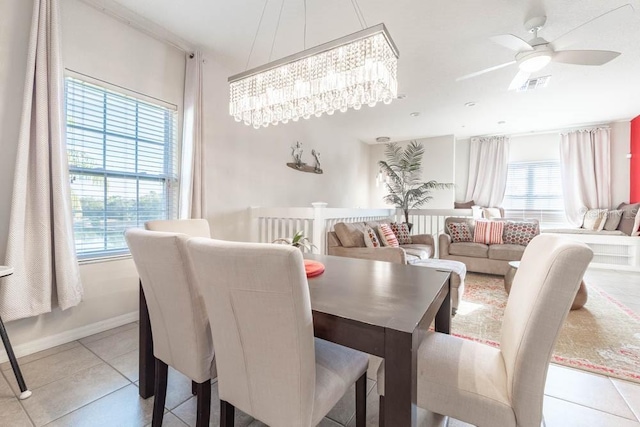 tiled dining space with ceiling fan and a healthy amount of sunlight