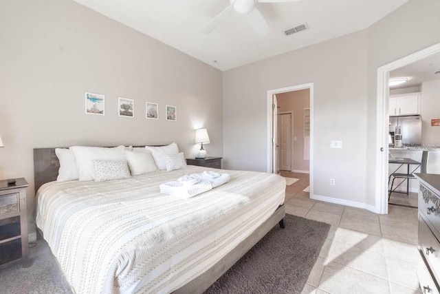 bedroom with ceiling fan, stainless steel refrigerator with ice dispenser, and light tile patterned flooring