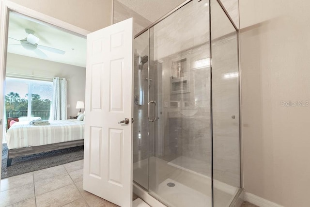 bathroom featuring ceiling fan, tile patterned floors, and a shower with door