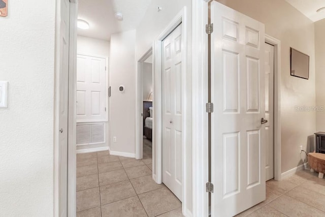 hallway with light tile patterned floors