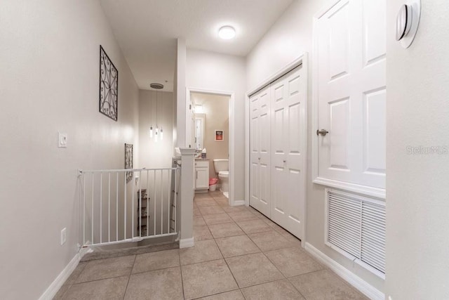 hall with light tile patterned floors