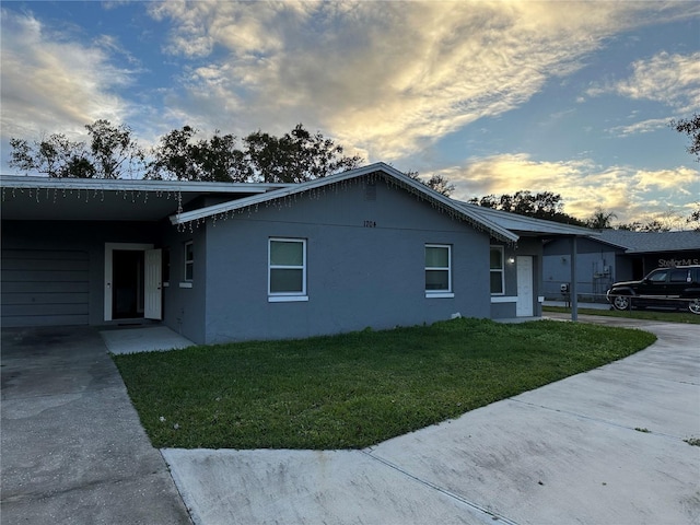 property exterior at dusk with a yard