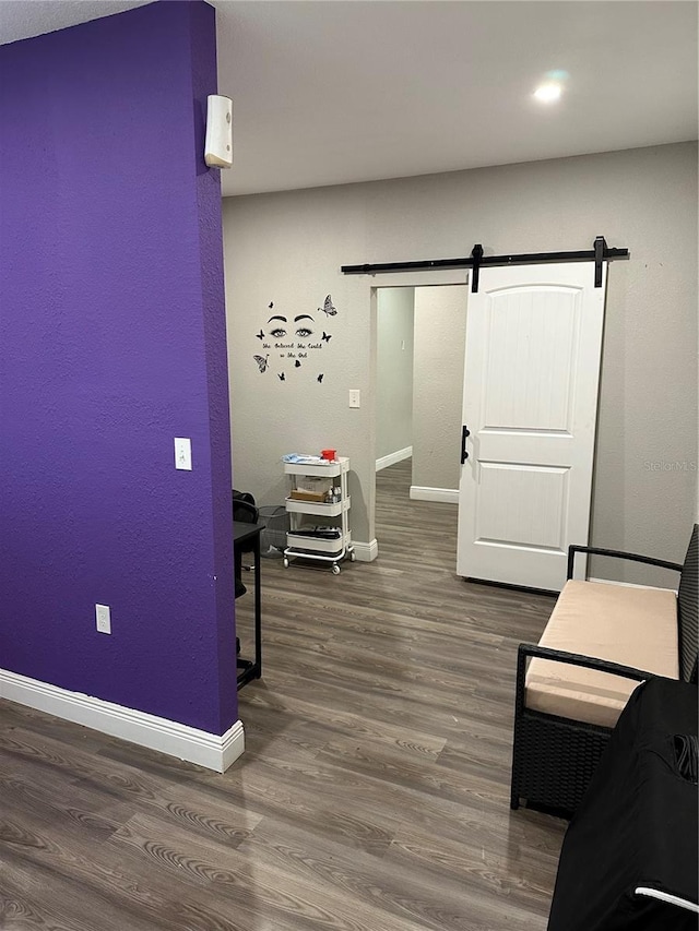 interior space featuring a barn door and dark hardwood / wood-style flooring