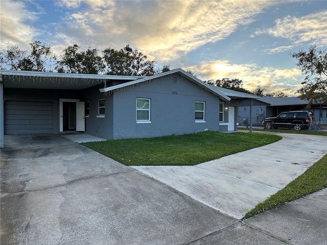 view of front of property with a yard and a carport