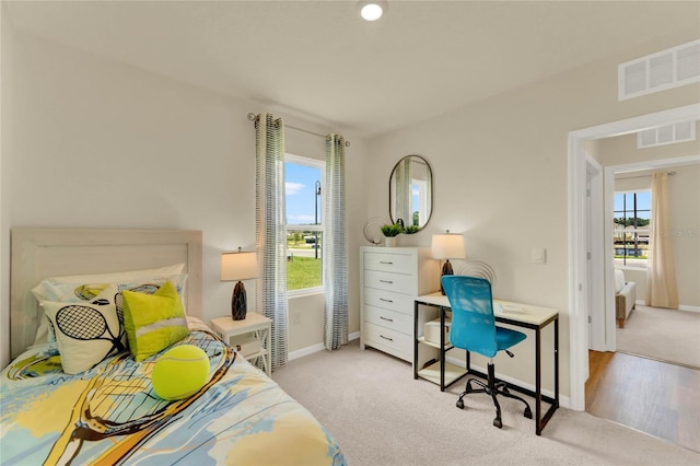 bedroom featuring light carpet