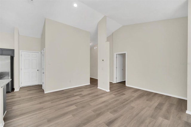 unfurnished living room featuring light hardwood / wood-style flooring and high vaulted ceiling