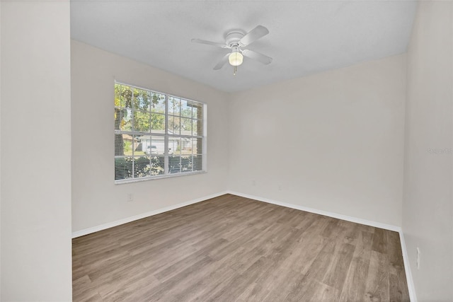 spare room featuring hardwood / wood-style flooring and ceiling fan