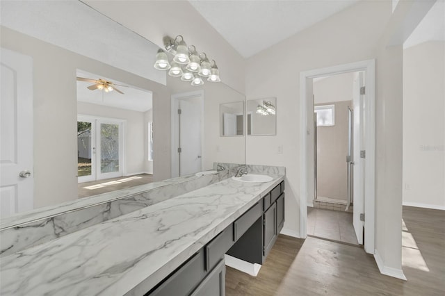 bathroom with vanity, hardwood / wood-style flooring, ceiling fan, and lofted ceiling