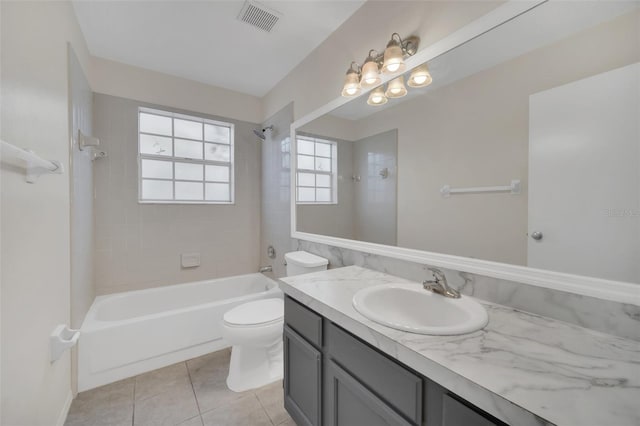 full bathroom with toilet, tile patterned flooring, vanity, and tiled shower / bath