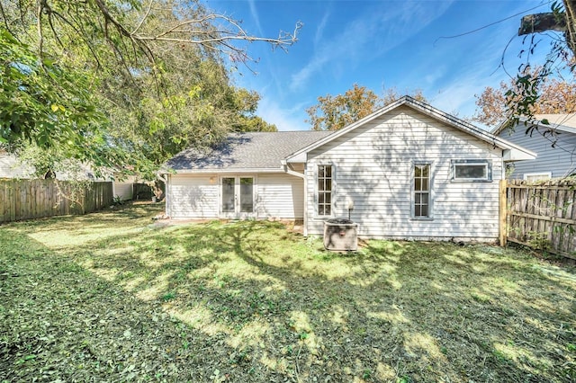 rear view of property with a lawn