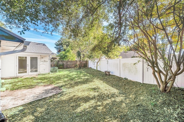 view of yard with a patio area, french doors, and central AC unit