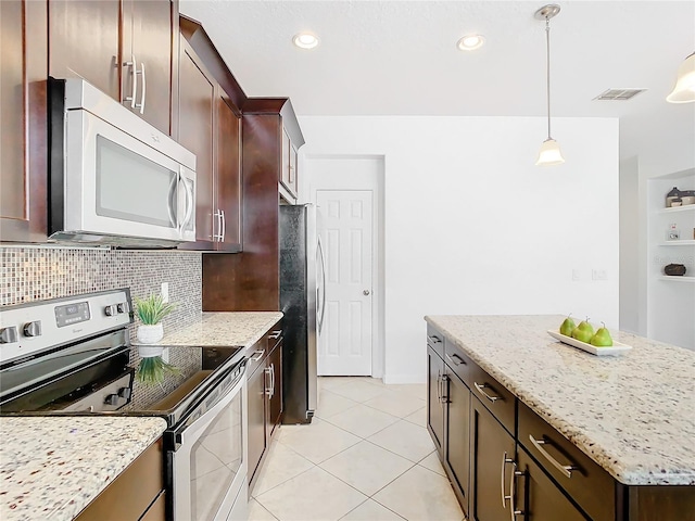 kitchen with appliances with stainless steel finishes, decorative light fixtures, decorative backsplash, light tile patterned floors, and light stone countertops