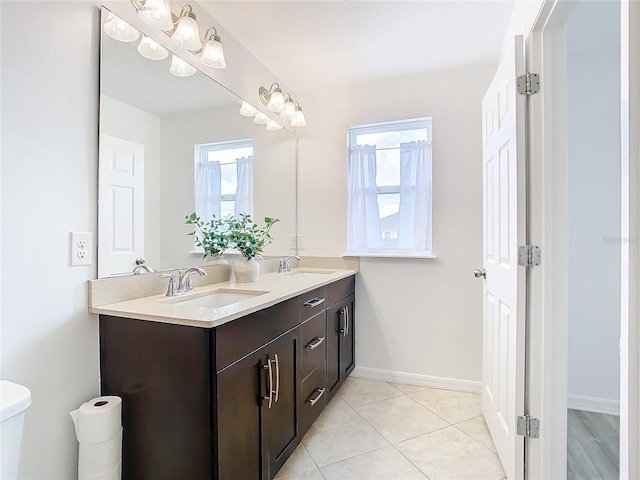 bathroom with vanity, toilet, and tile patterned flooring