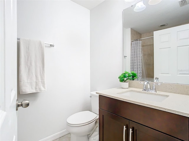 bathroom featuring vanity, a shower with shower curtain, and toilet