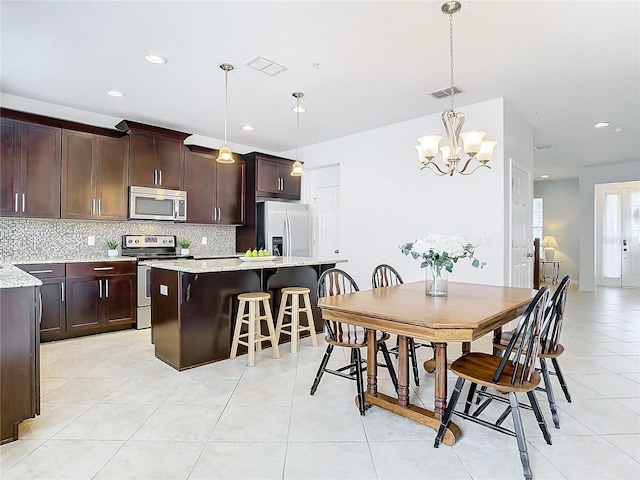 tiled dining space with a notable chandelier