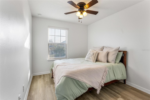 bedroom with ceiling fan and light hardwood / wood-style floors