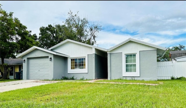 ranch-style home featuring a garage and a front lawn