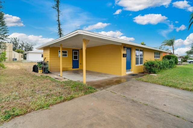 ranch-style house with a carport and a front yard