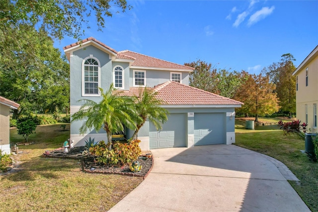 mediterranean / spanish-style house featuring a garage and a front lawn