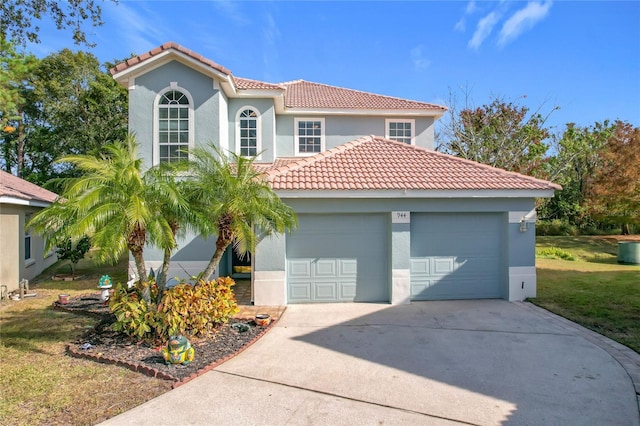 mediterranean / spanish-style house with a garage and a front lawn