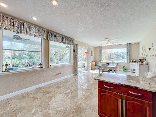 kitchen featuring light stone countertops and a textured ceiling