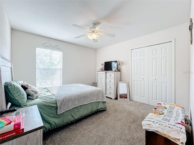 bedroom featuring carpet, a textured ceiling, a closet, and ceiling fan