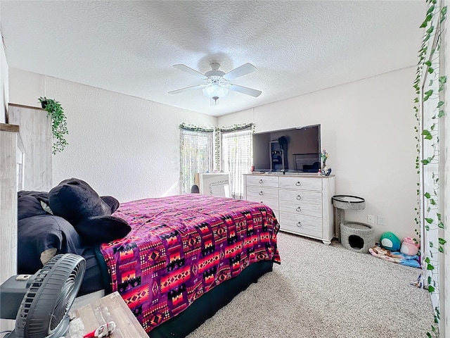 bedroom with a textured ceiling, ceiling fan, and light carpet