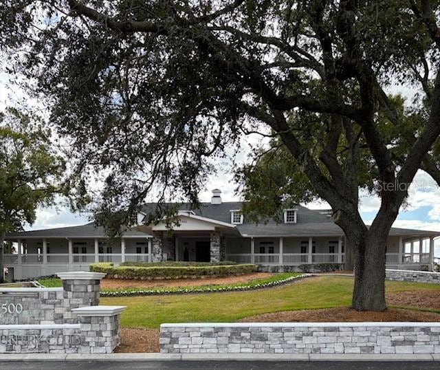 farmhouse-style home with a front lawn