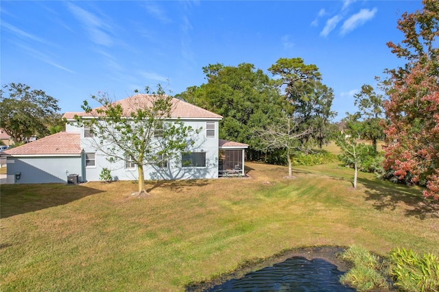 view of yard with a sunroom and central air condition unit