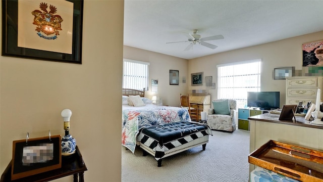 bedroom with carpet, ceiling fan, and multiple windows