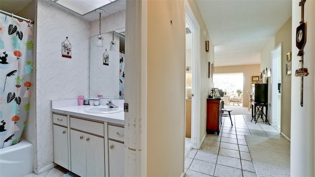 bathroom with vanity, tile patterned floors, and shower / bath combo with shower curtain