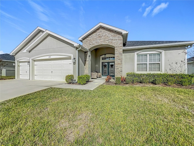 single story home featuring french doors, a front lawn, and a garage