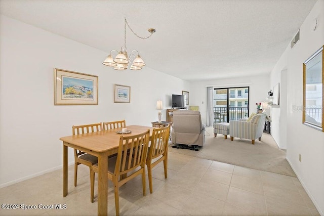 carpeted dining room with a chandelier