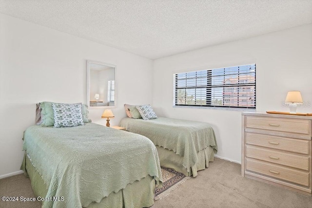 carpeted bedroom featuring a textured ceiling