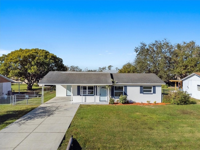 ranch-style home with covered porch, a front yard, and a carport